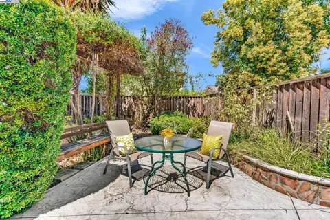 a view of a chairs and table in backyard