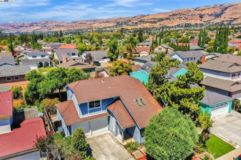 an aerial view of a houses with a city view