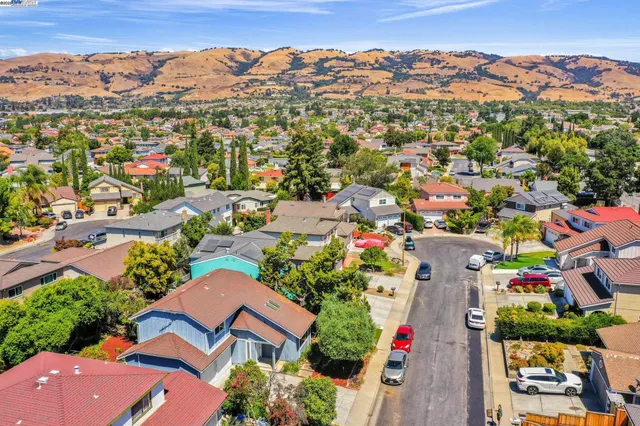 an aerial view of multiple houses with yard