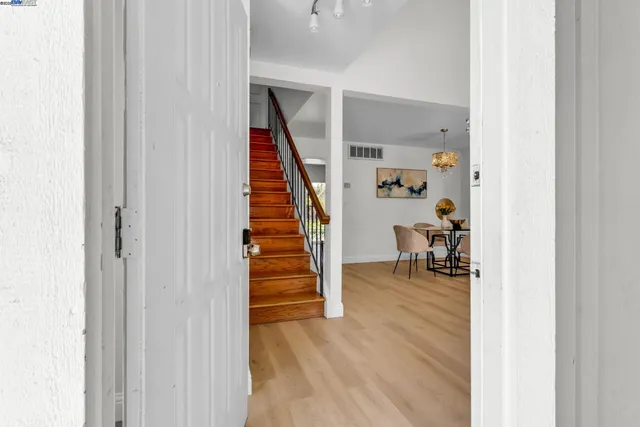 a view of hallway with wooden floor and stairs