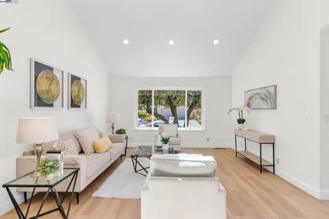 a living room with furniture and painting on the wall