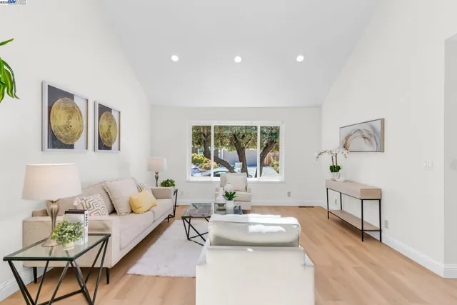 a living room with furniture and painting on the wall