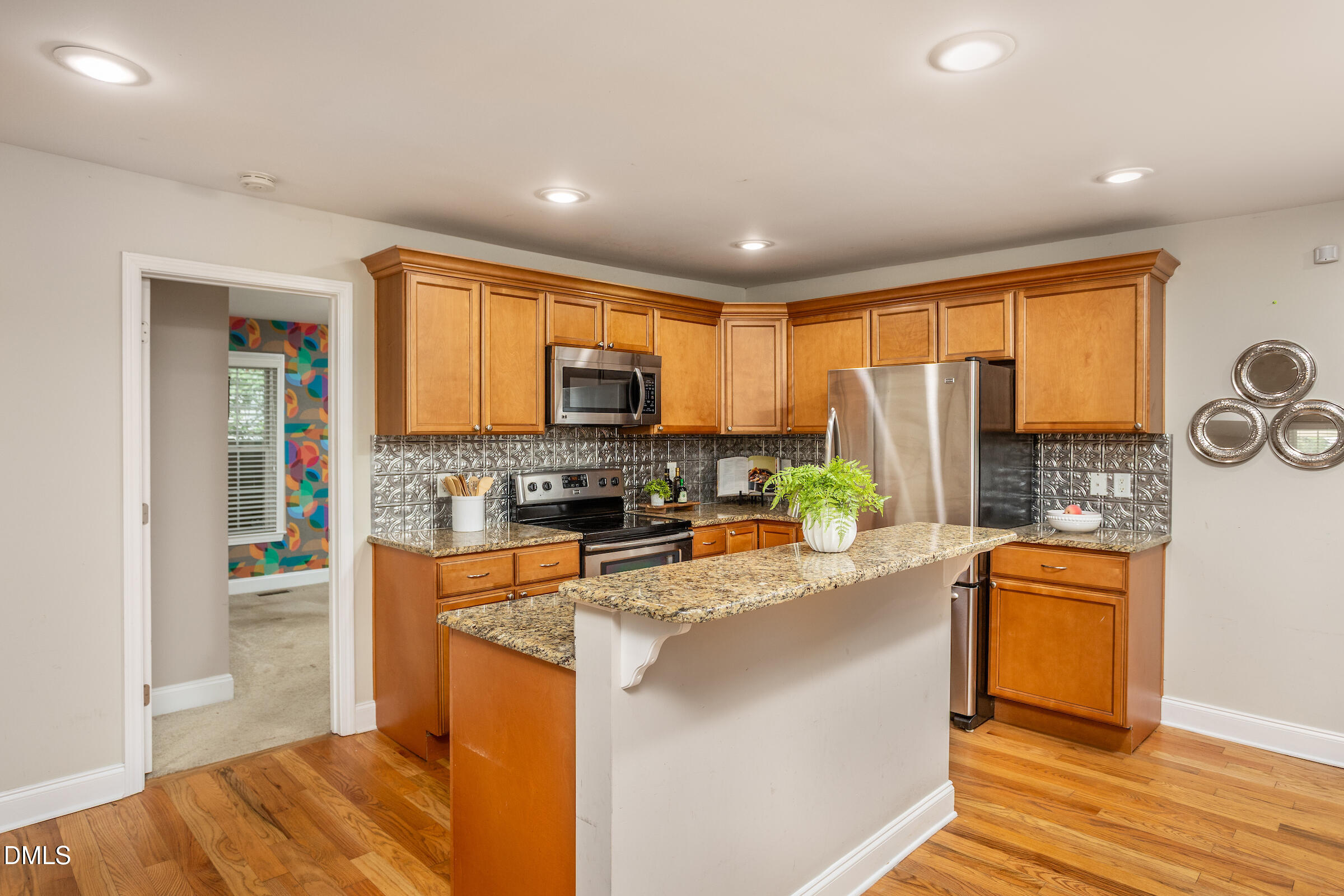 305 Freeman Street Raleigh, NC 27601 - Photo 8 of 15 a kitchen with stainless steel appliances granite countertop a stove top oven a sink dishwasher a refrigerator and a dining table with wooden floor