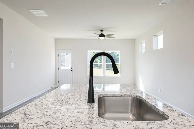a close view of a sink a faucet and appliance in the kitchen