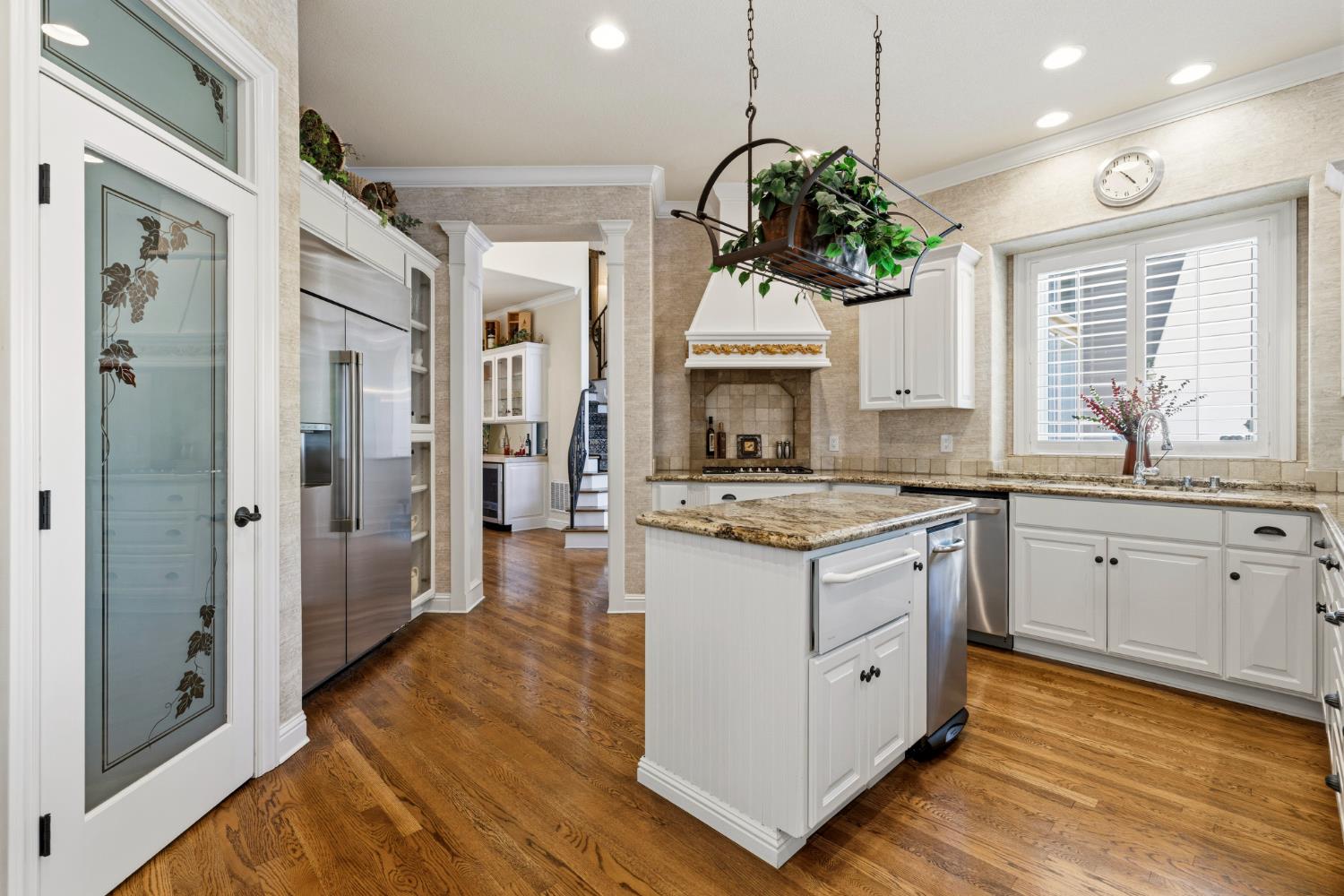 5869 Granite Hills Drive South Granite Bay, CA 95746 - Photo 11 of 66 a kitchen with stainless steel appliances granite countertop a stove a sink dishwasher a refrigerator and a fireplace with wooden floor