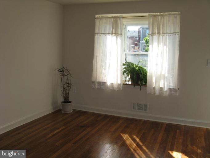 1925 Frames Road Dundalk, MD 21222 - Photo 3 of 14 a room with a window and wooden floor
