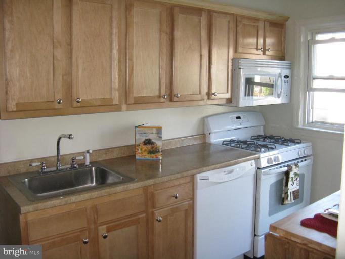 1925 Frames Road Dundalk, MD 21222 - Photo 7 of 14 a kitchen with stainless steel appliances granite countertop a sink stove and cabinets