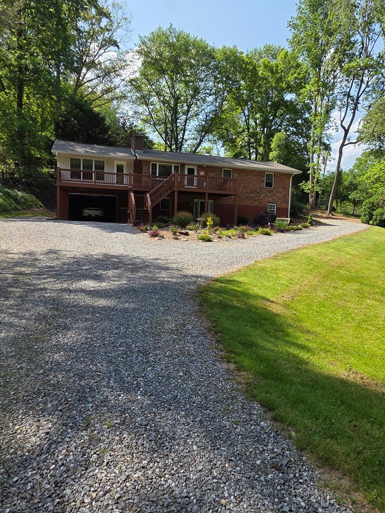 a view of house with outdoor space and garden