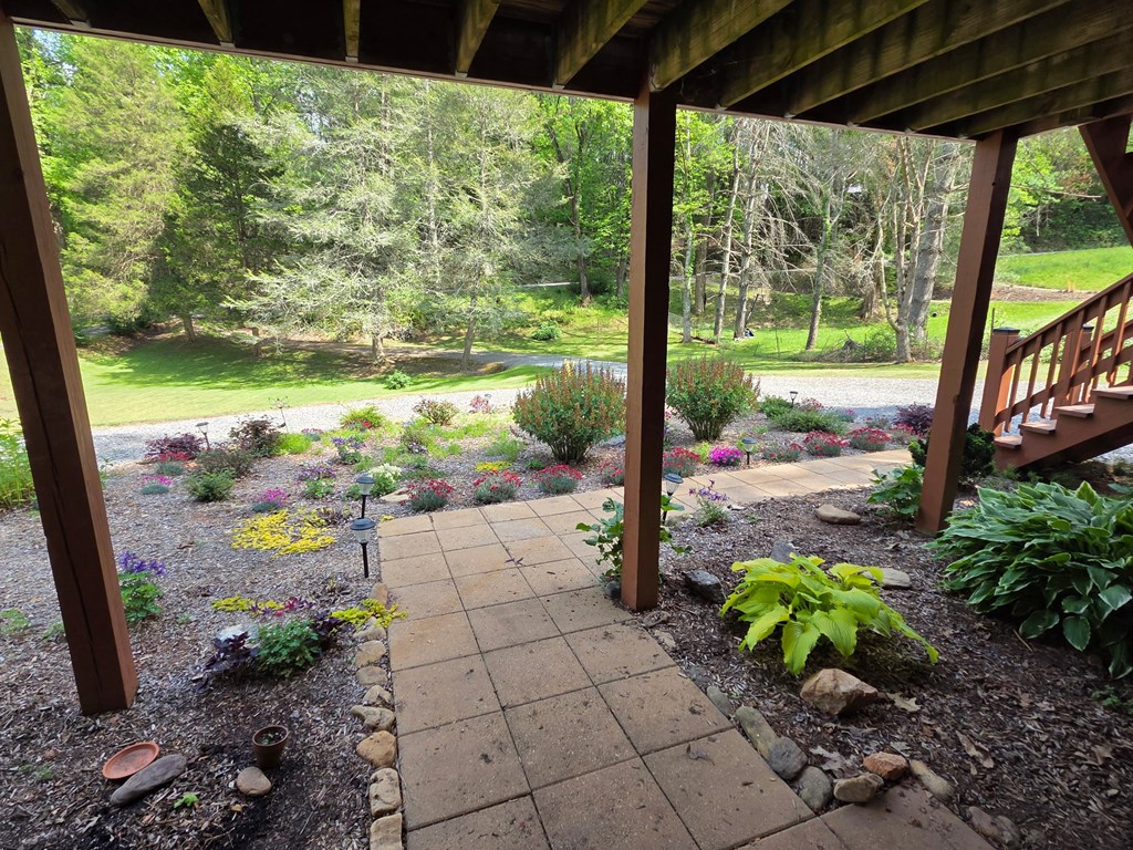 208 Ledford Chapel Road Hayesville, NC 28904 - Photo 24 of 35 a view of a garden with lawn chairs plants and swimming pool