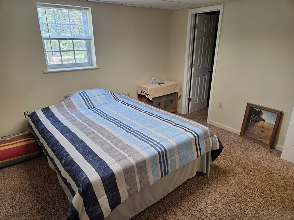 208 Ledford Chapel Road Hayesville, NC 28904 - Photo 29 of 35 a bedroom with a bed and wooden floor