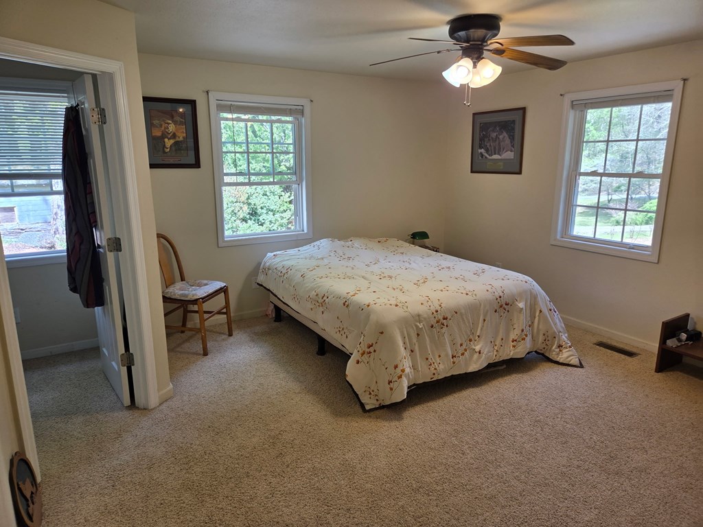 208 Ledford Chapel Road Hayesville, NC 28904 - Photo 4 of 35 a bed sitting in a bedroom next to a window
