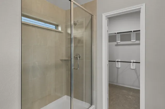 a bathroom with a glass shower door