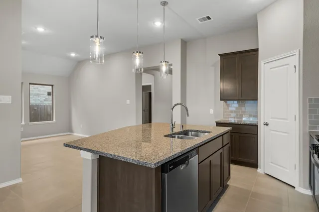 a kitchen with a sink a counter space and appliances
