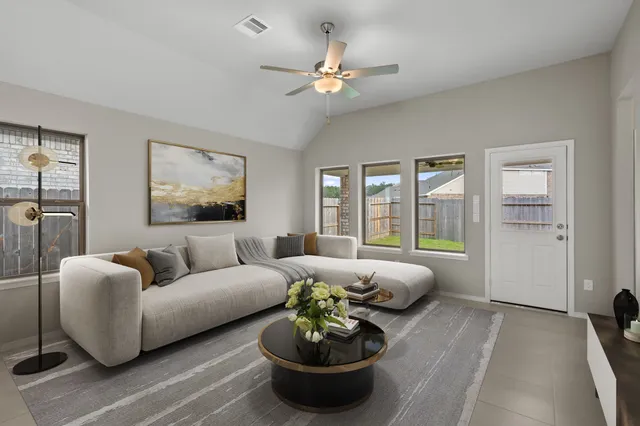 a living room with furniture and a large window