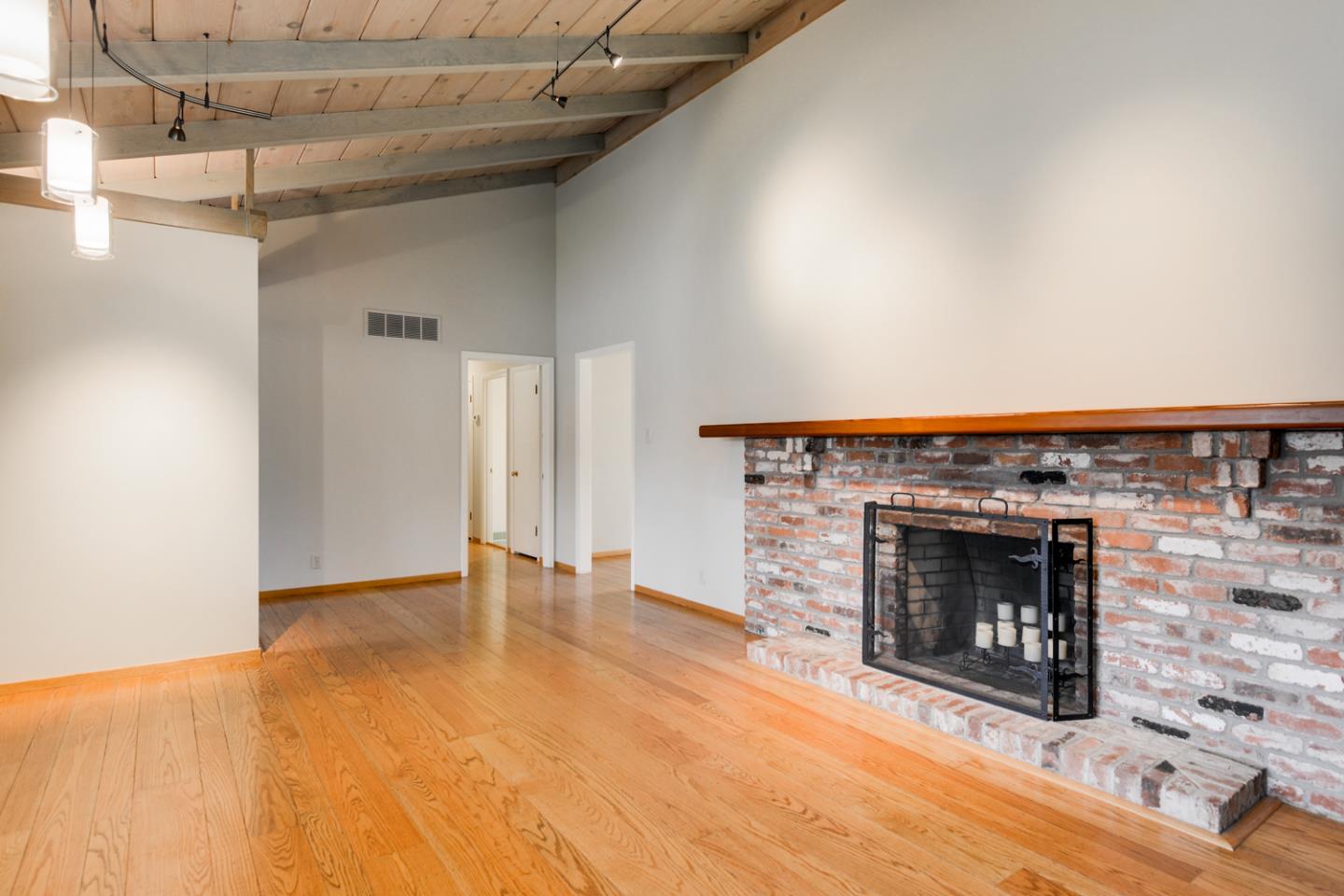390 Cherry Avenue Los Altos, CA 94022 - Photo 3 of 27 a view of an empty room with fire place and a fireplace