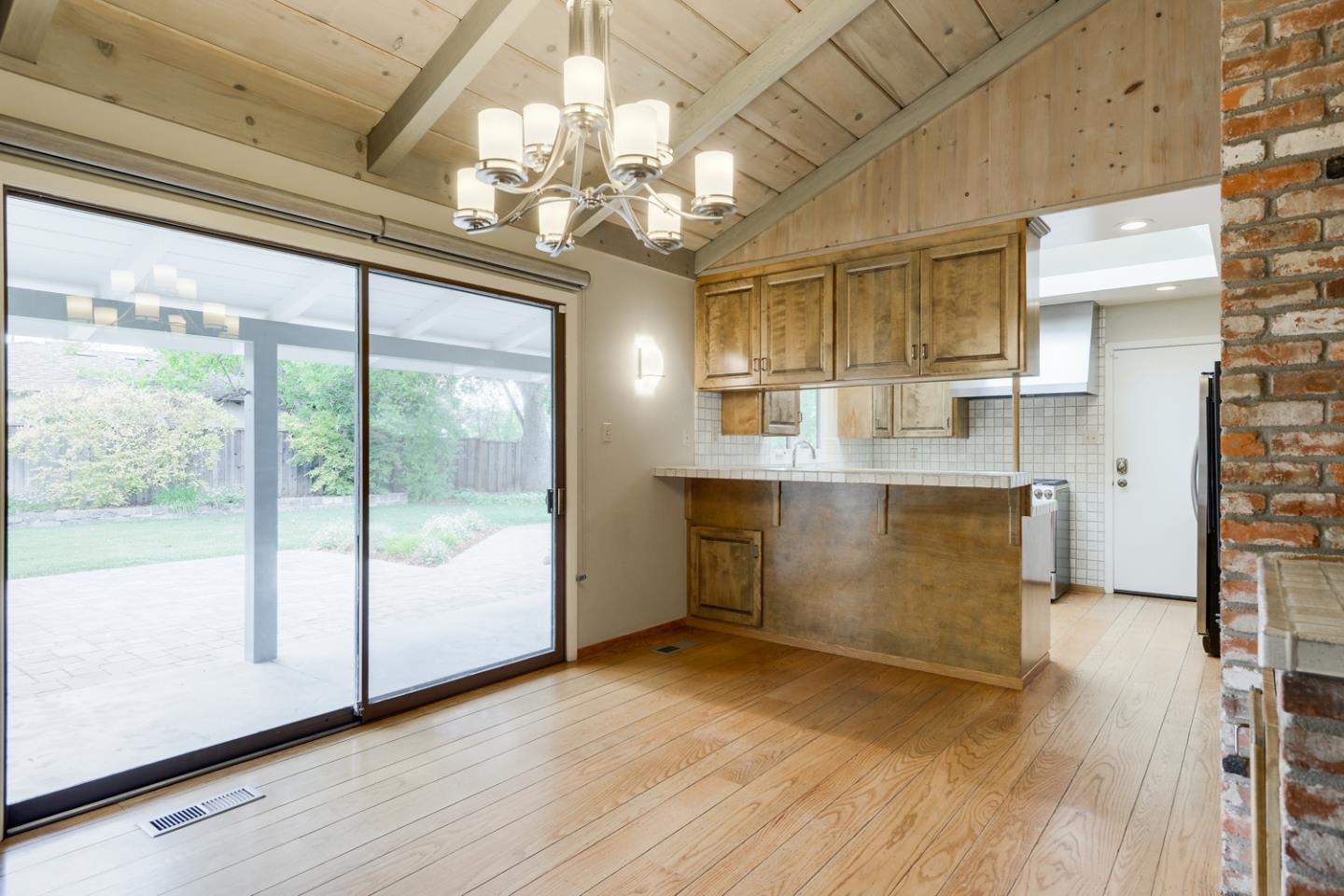 390 Cherry Avenue Los Altos, CA 94022 - Photo 5 of 27 a view of a room with wooden floor and chandelier