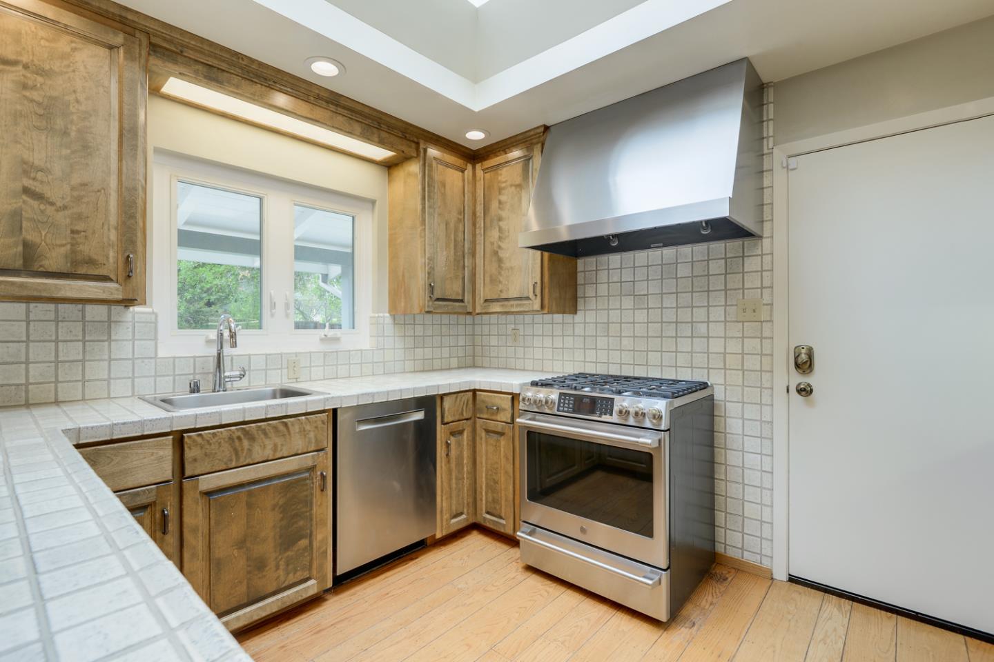 390 Cherry Avenue Los Altos, CA 94022 - Photo 7 of 27 a kitchen with a stove sink and cabinets