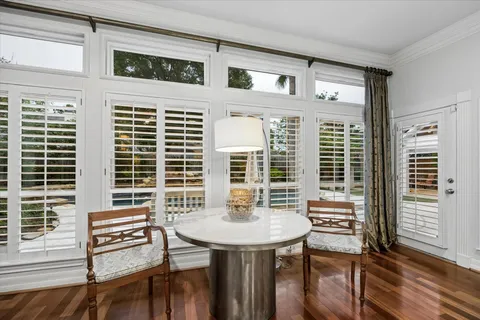 a view of a dining room with furniture and window