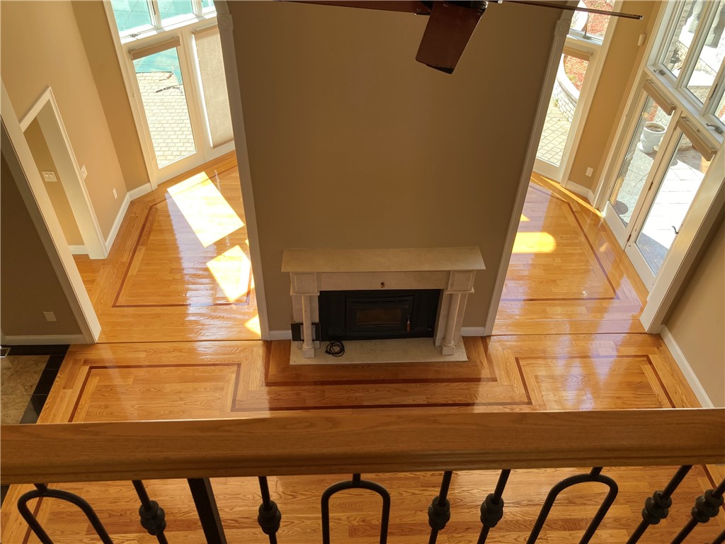 1 Christopher Drive Lincoln, RI 02865 - Photo 13 of 48 Living room with 2 story ceiling and wood burning marble surround Fireplace.