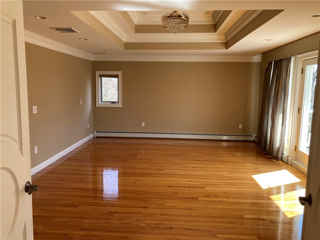 1 Christopher Drive Lincoln, RI 02865 - Photo 19 of 48 Spacious primary ensuite with tray ceiling and double doors leading to a private balcony.
