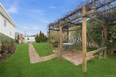 a view of a chair and table in the garden