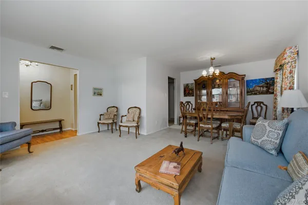 a living room with furniture and gym equipment