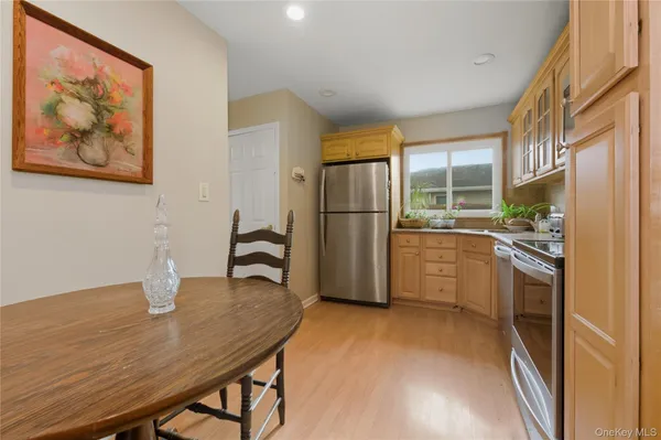 a kitchen with stainless steel appliances a refrigerator and a stove top oven