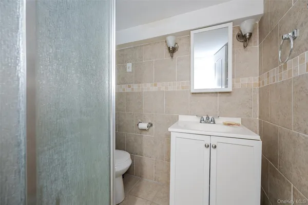 a bathroom with a sink toilet and vanity