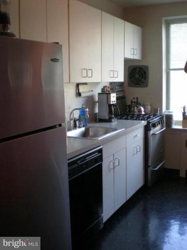 4100 W Street Northwest, Unit 510 Washington, DC 20007 - Photo 5 of 12 a kitchen with a sink appliances and cabinets