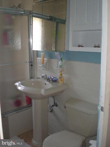4100 W Street Northwest, Unit 510 Washington, DC 20007 - Photo 9 of 12 a bathroom with a sink toilet and shower