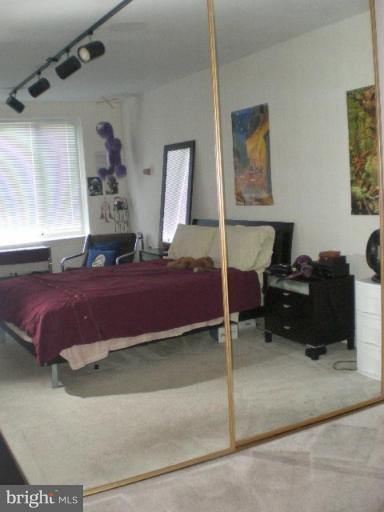 4100 W Street Northwest, Unit 510 Washington, DC 20007 - Photo 10 of 12 a bedroom with a bed and a dresser