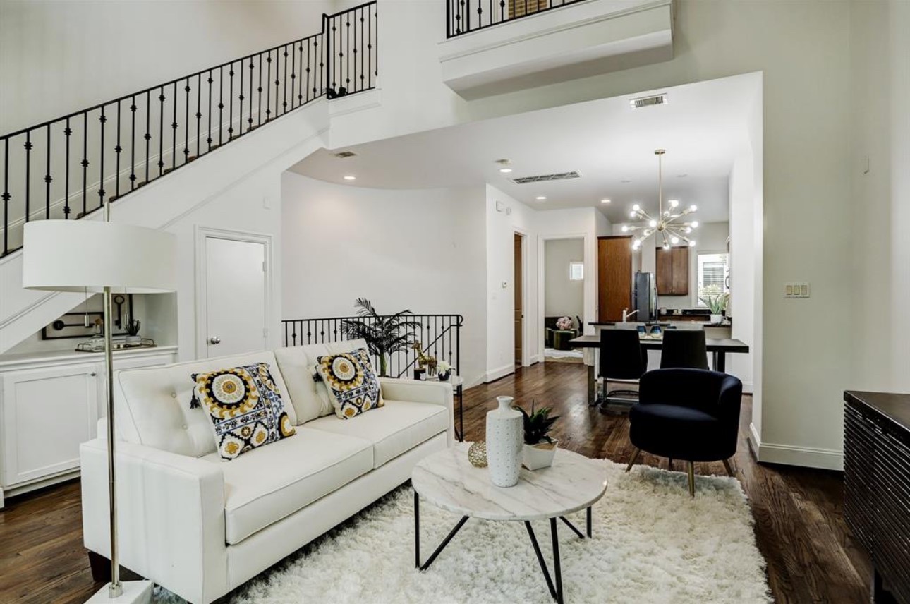 a living room with furniture and wooden floor