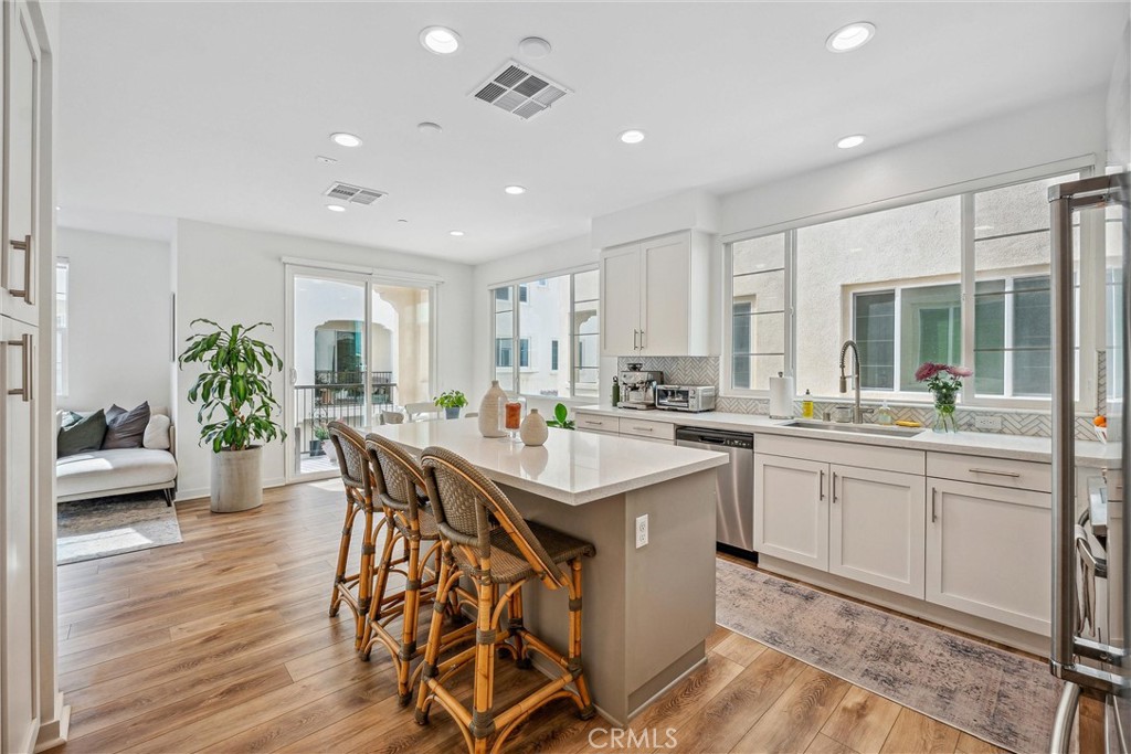 318 Ford Road Costa Mesa, CA 92627 - Photo 8 of 20 a kitchen with counter space dining table and chairs