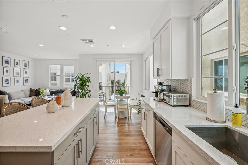 318 Ford Road Costa Mesa, CA 92627 - Photo 10 of 20 a view of a kitchen with kitchen island a large counter space a sink stainless steel appliances and windows
