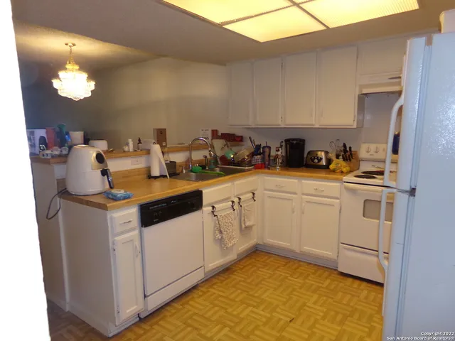 a kitchen with a sink cabinets and appliances