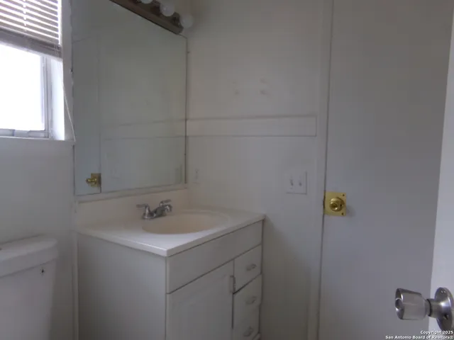 a bathroom with a sink and vanity