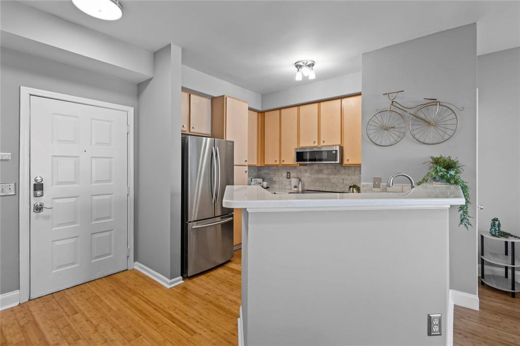 821 Ralph McGill Boulevard Northeast, Unit 3301 Atlanta, GA 30306 - Photo 12 of 31 a kitchen with stainless steel appliances a refrigerator sink and cabinets