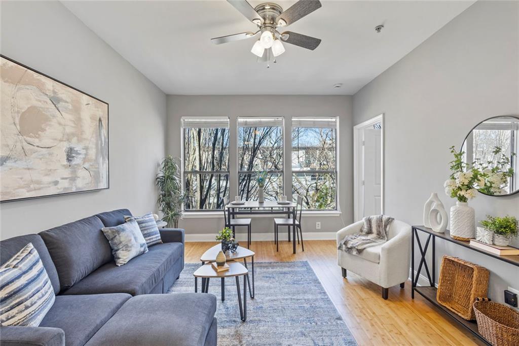 821 Ralph McGill Boulevard Northeast, Unit 3301 Atlanta, GA 30306 - Photo 13 of 31 a living room with furniture and a large window