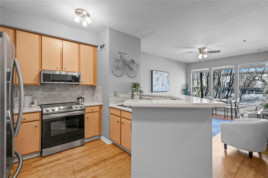 821 Ralph McGill Boulevard Northeast, Unit 3301 Atlanta, GA 30306 - Photo 5 of 31 a kitchen with stainless steel appliances granite countertop a stove and a sink