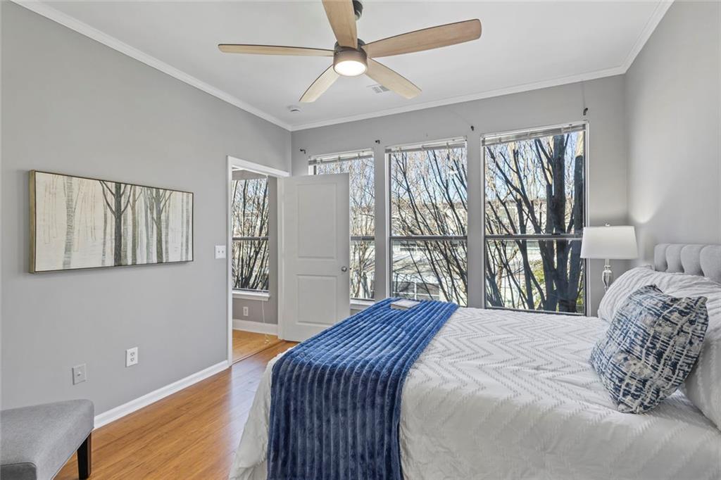 821 Ralph McGill Boulevard Northeast, Unit 3301 Atlanta, GA 30306 - Photo 6 of 31 a bedroom with a large bed and a chandelier