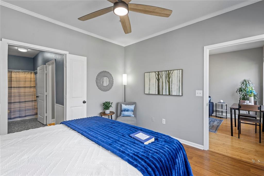 821 Ralph McGill Boulevard Northeast, Unit 3301 Atlanta, GA 30306 - Photo 7 of 31 a bedroom with a bed and a chandelier