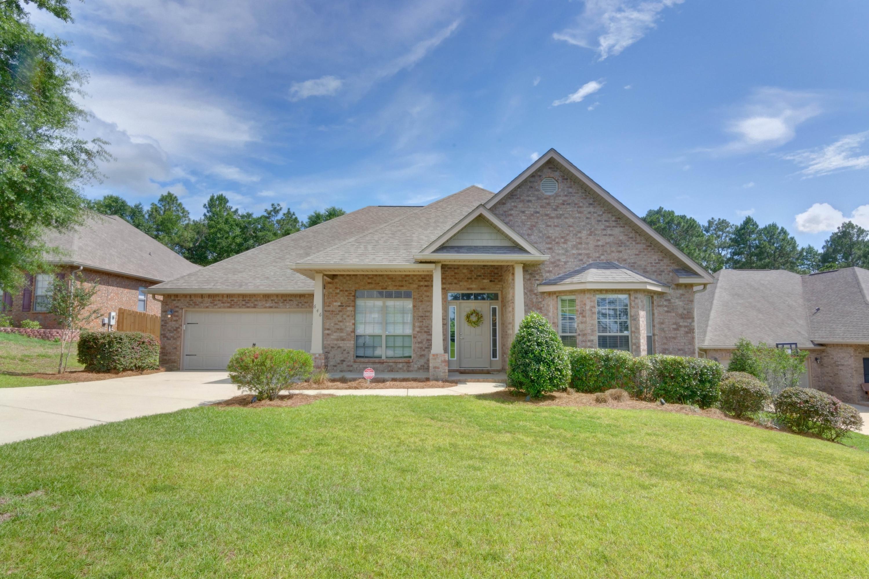 646 Red Fern Road Crestview, FL 32536 - Photo 1 of 64 a front view of a house with a yard and potted plants