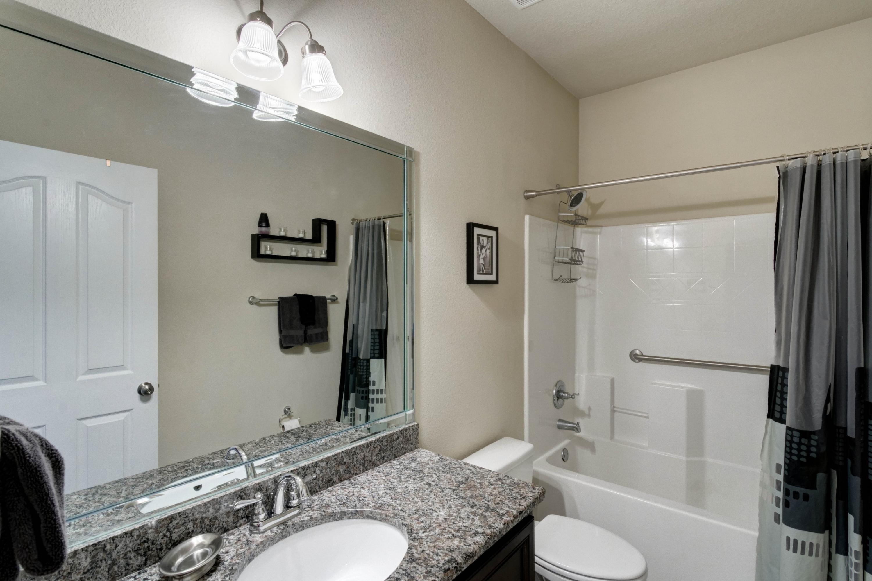 646 Red Fern Road Crestview, FL 32536 - Photo 16 of 64 a bathroom with a granite countertop sink toilet and shower