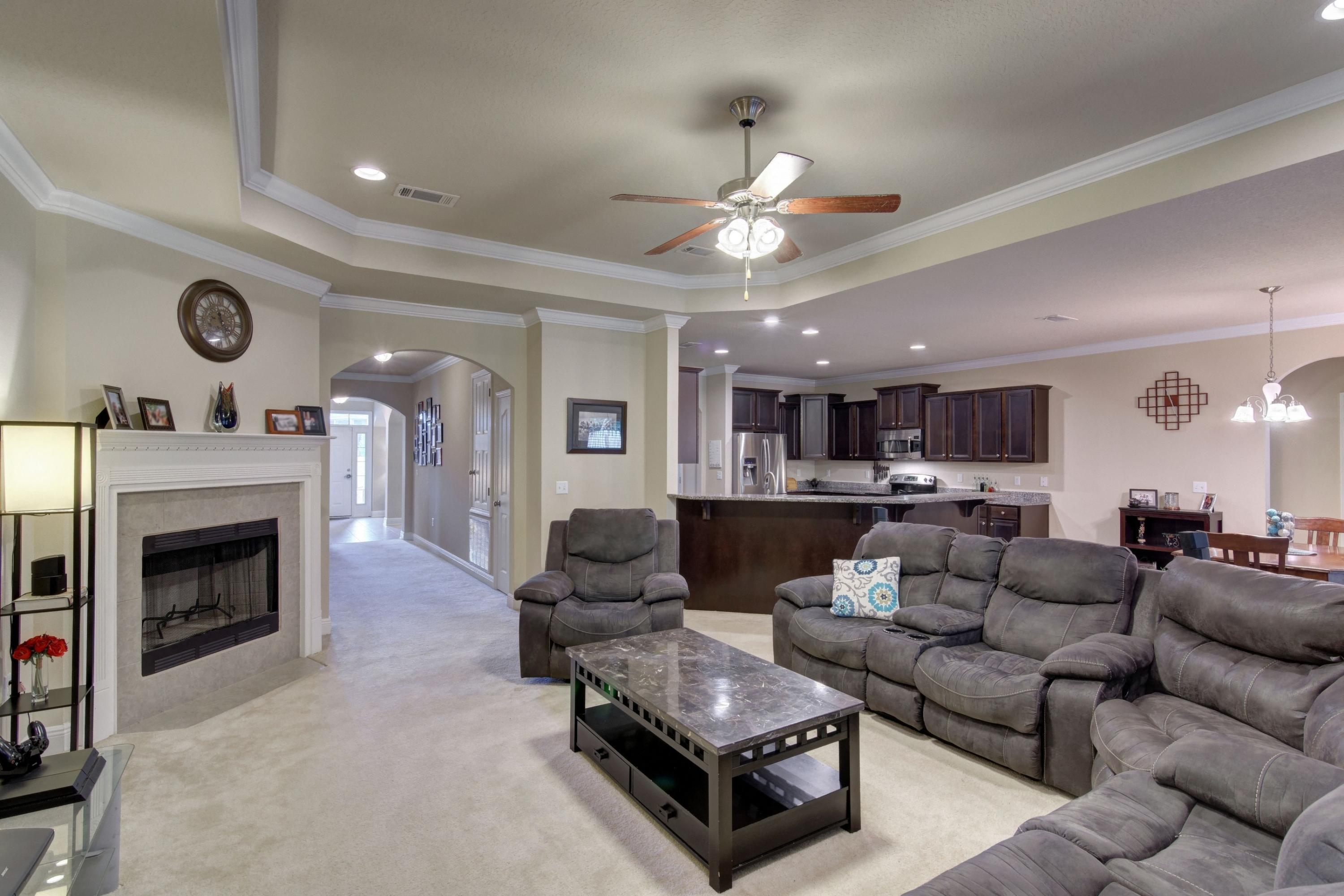 646 Red Fern Road Crestview, FL 32536 - Photo 21 of 64 a living room with furniture kitchen view and a fireplace