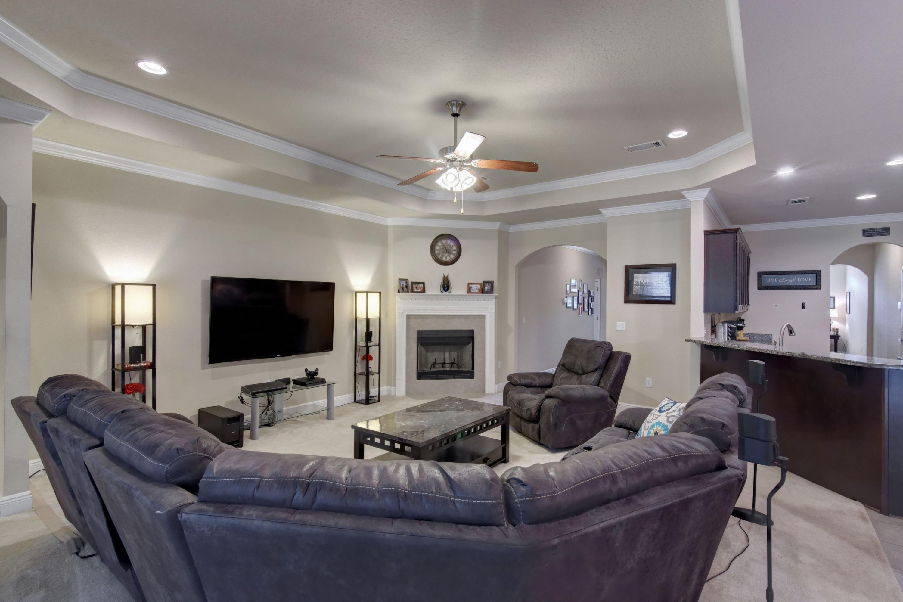 646 Red Fern Road Crestview, FL 32536 - Photo 22 of 64 a living room with furniture a fireplace and a flat screen tv