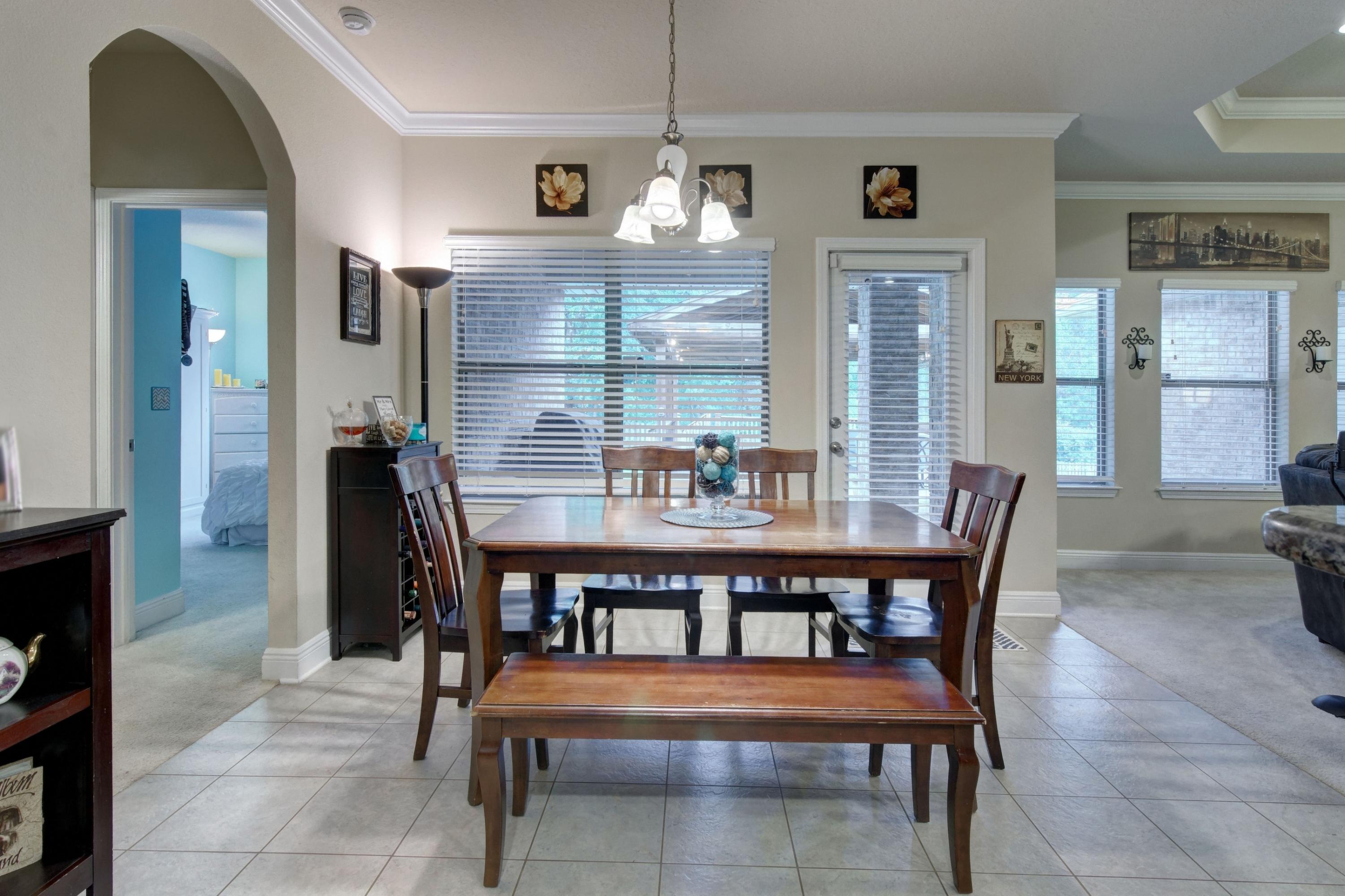 646 Red Fern Road Crestview, FL 32536 - Photo 27 of 64 a dining room with a wooden table and chairs