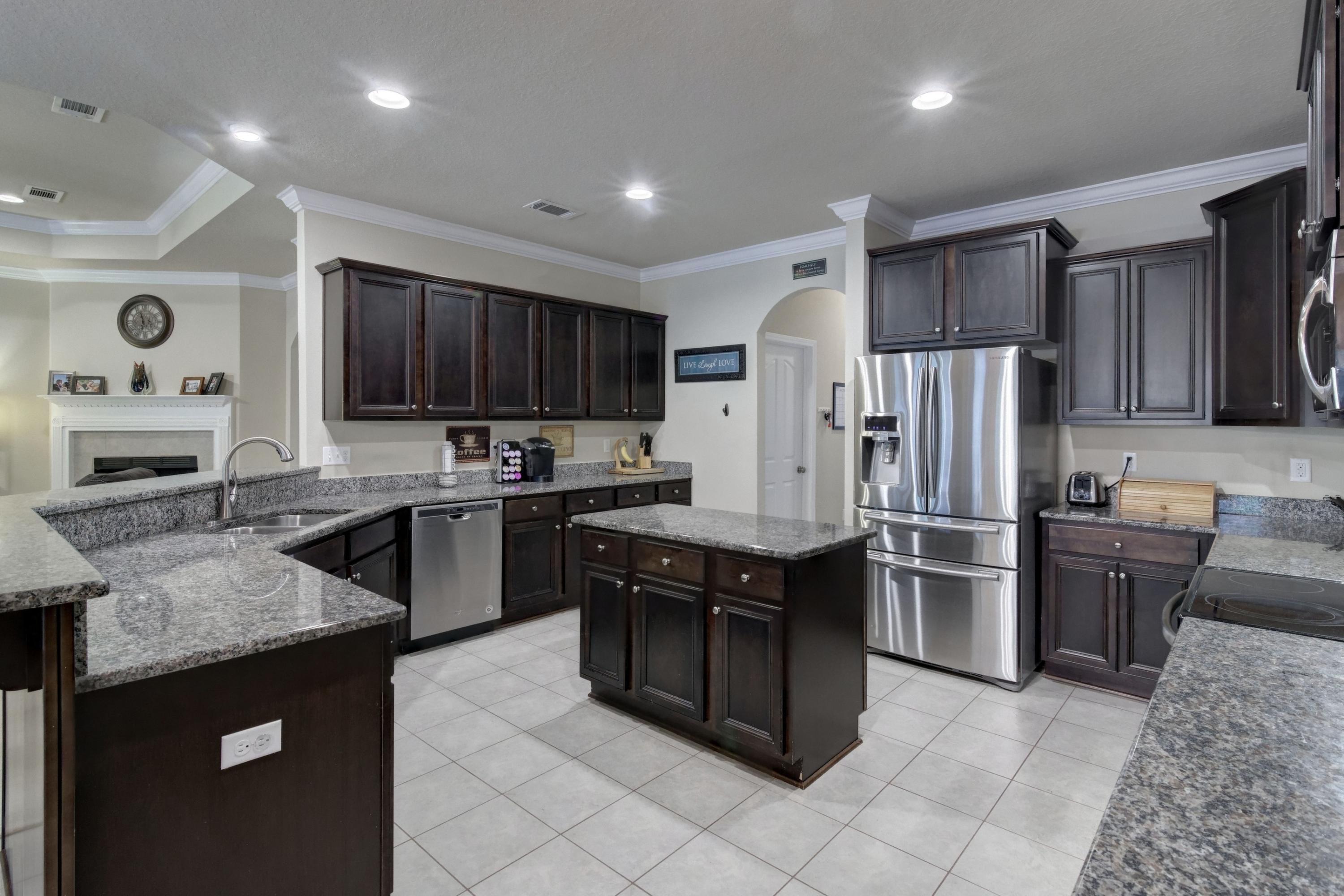 646 Red Fern Road Crestview, FL 32536 - Photo 28 of 64 a kitchen with stainless steel appliances granite countertop a stove refrigerator and a sink
