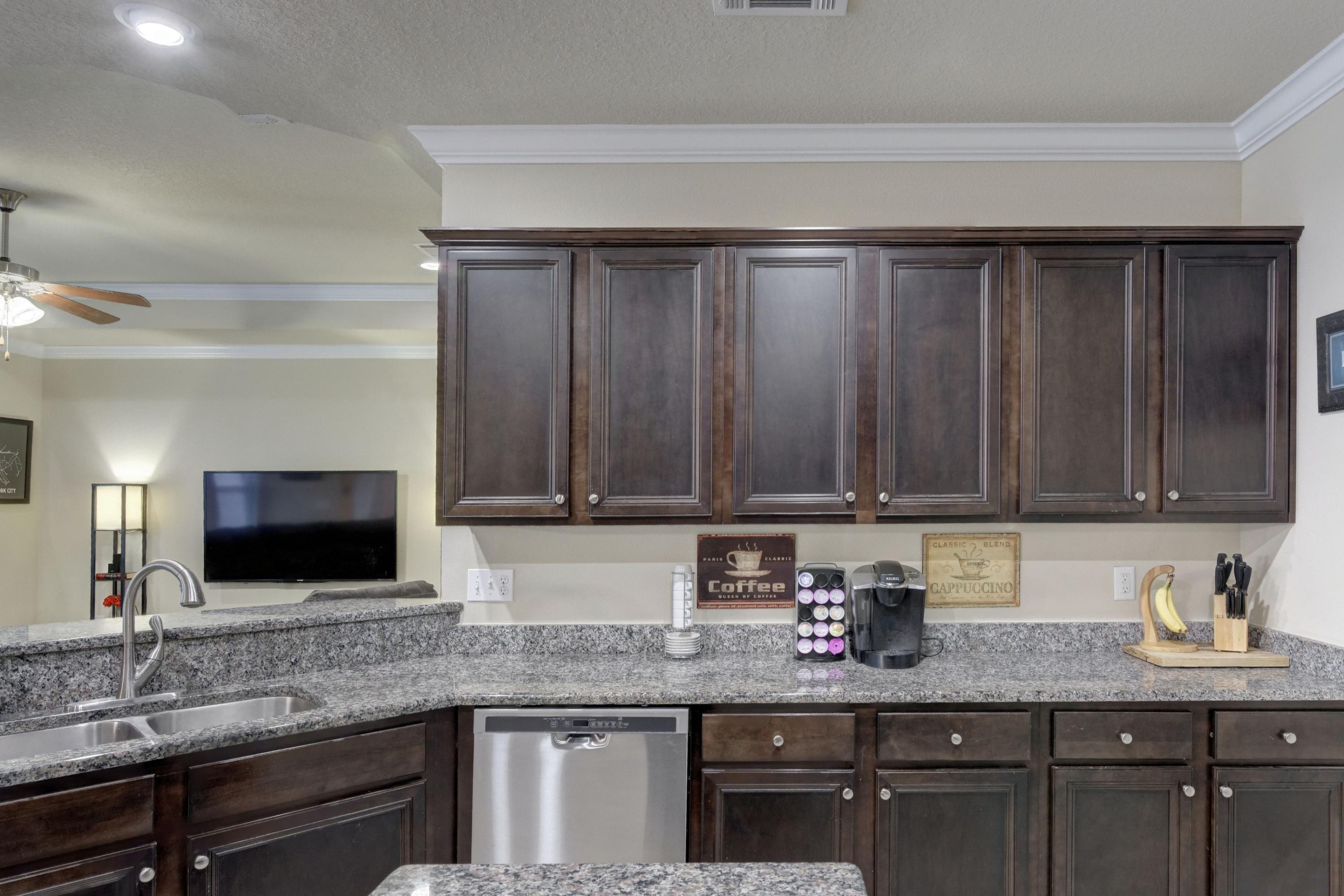 646 Red Fern Road Crestview, FL 32536 - Photo 33 of 64 a kitchen with granite countertop stainless steel appliances a sink window and cabinets