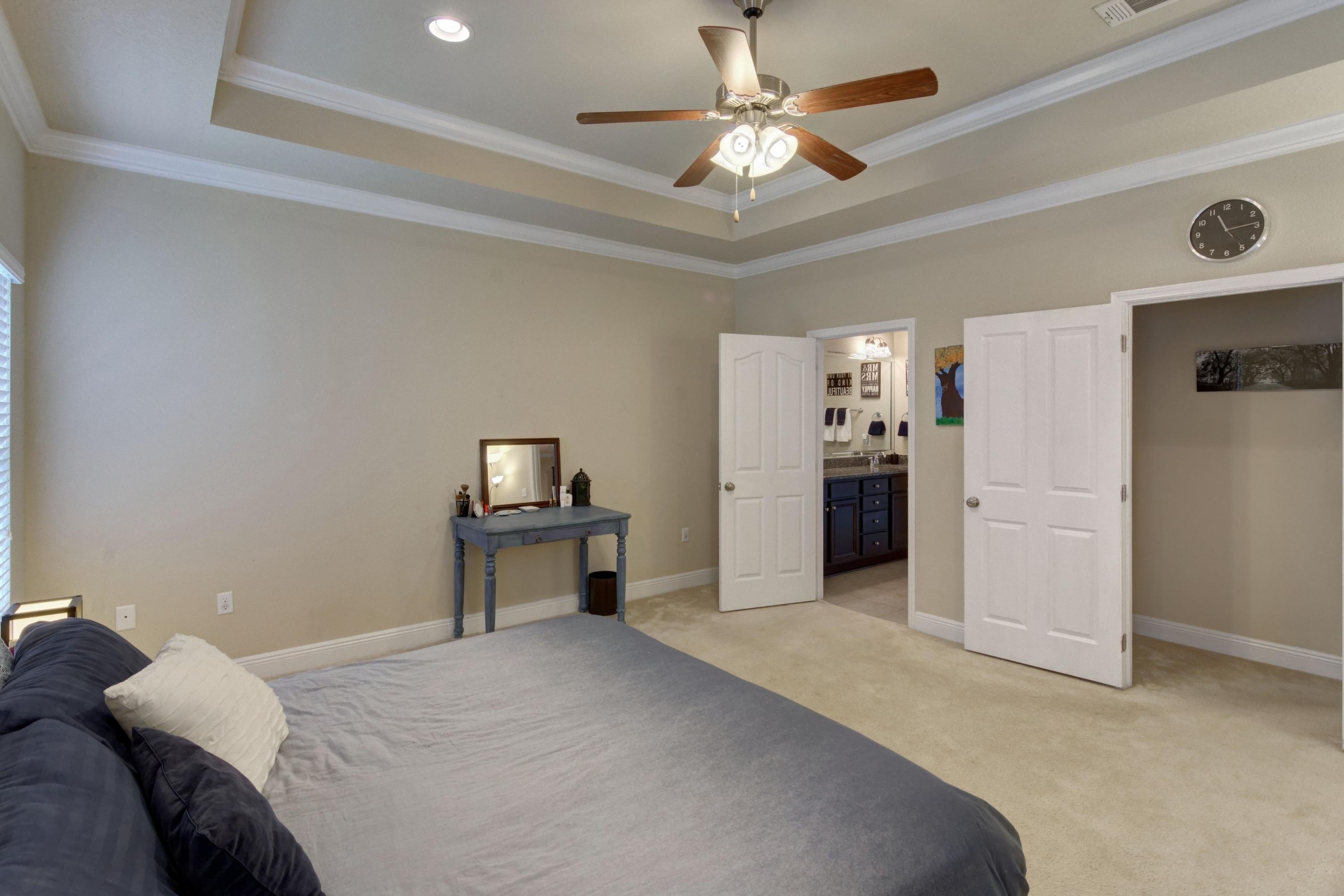 646 Red Fern Road Crestview, FL 32536 - Photo 35 of 64 a bedroom with a bed and a chandelier