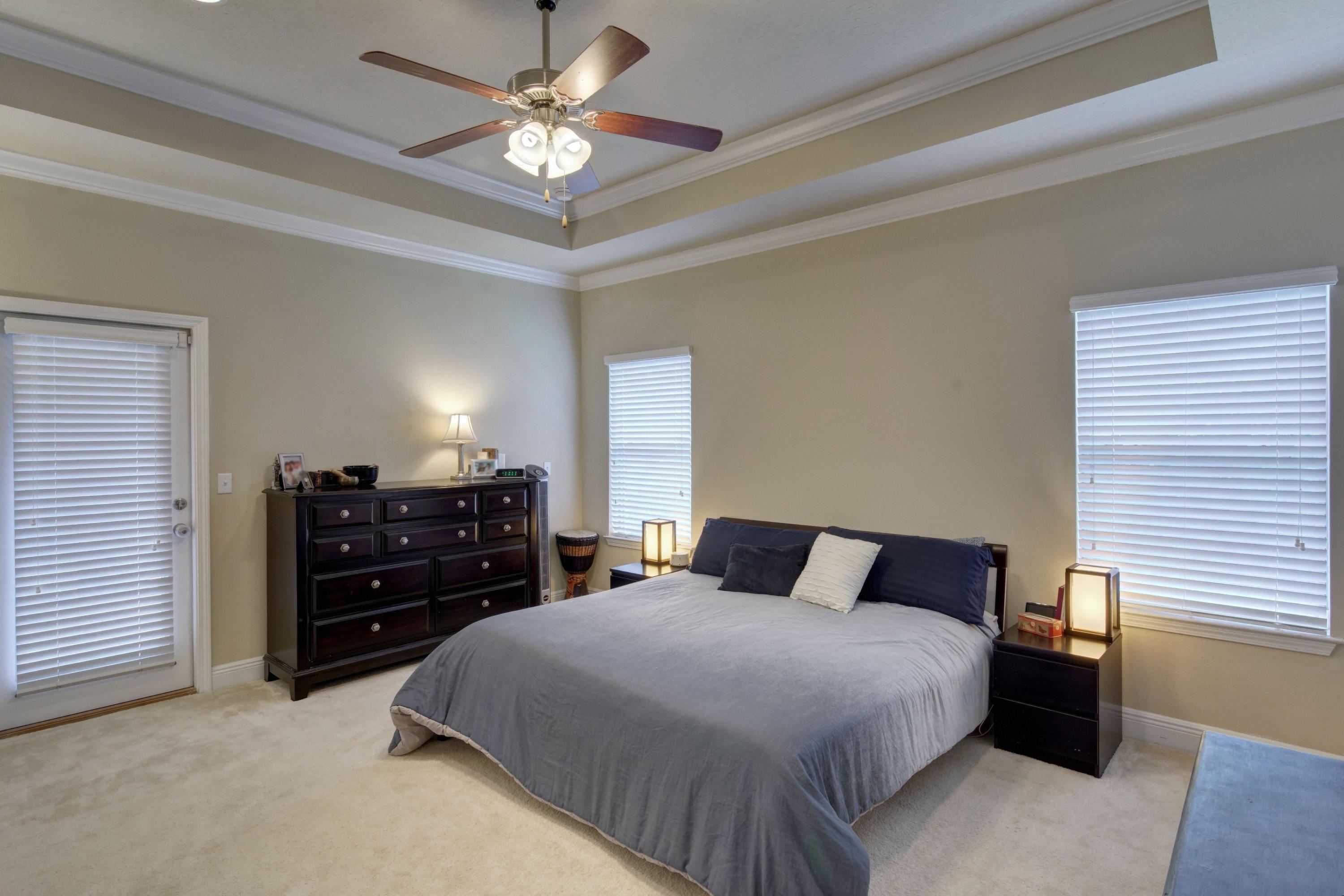 646 Red Fern Road Crestview, FL 32536 - Photo 37 of 64 a bedroom with a bed and a chandelier